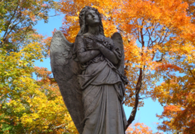 angel statue with fall leaves in background