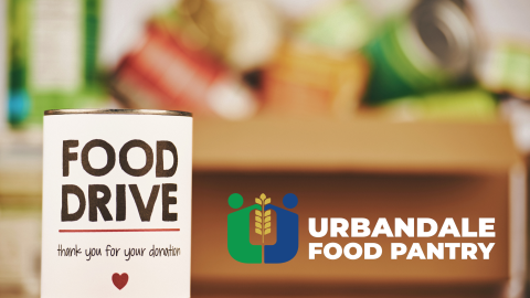 Canned food in a box with the words "Food Drive, thank you for your donation," on one of the cans. The Urbandale Food Pantry logo is in the corner of the picture and the letter U looks like two bodies holding up a stalk of wheat in the middle.