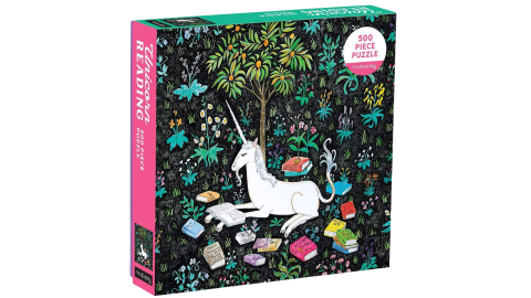 A jigsaw puzzle box with an image of a unicorn in a forest surrounded by books.