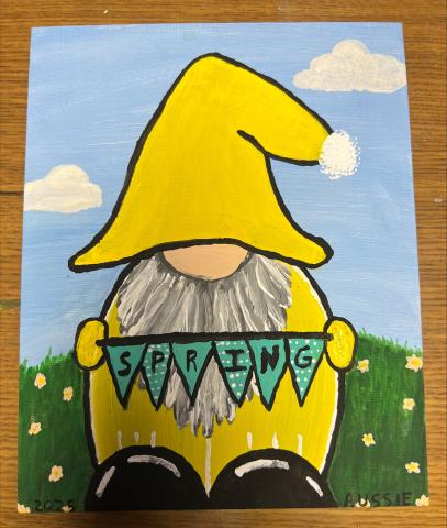 gnome wearing yellow hat and jacket with spring banner