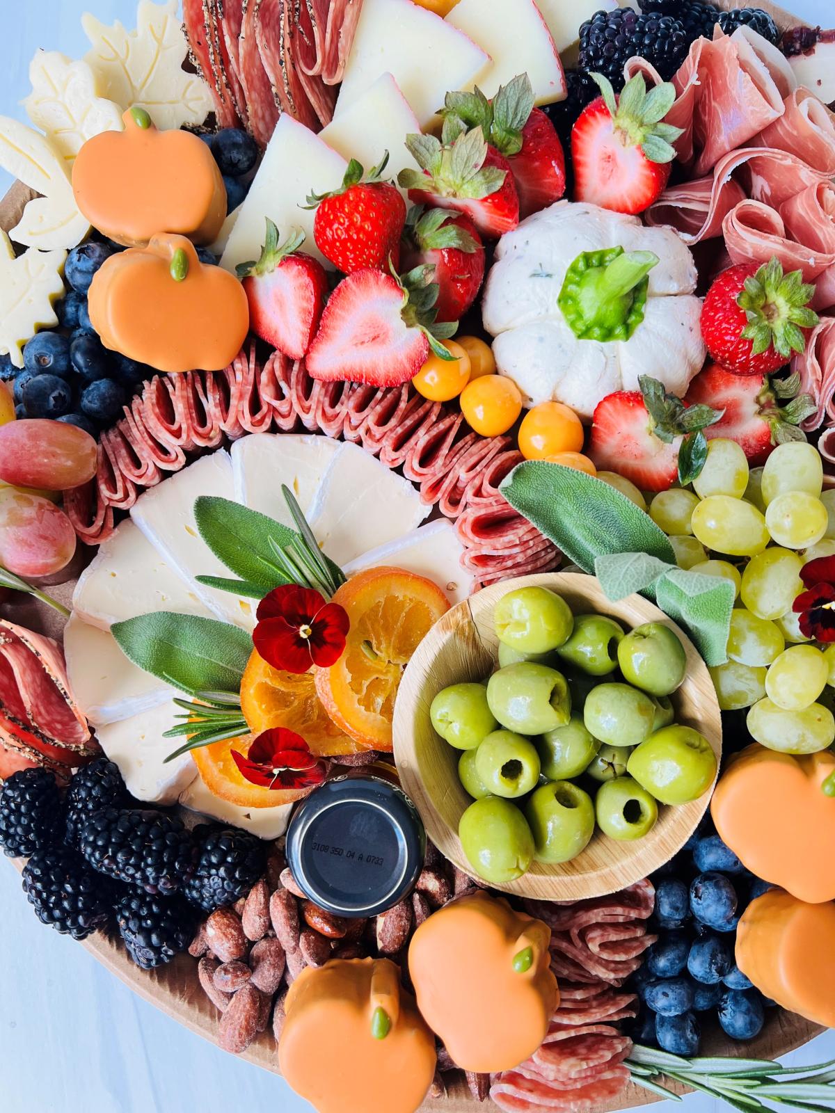 charcuterie board with meats, cheeses, fruits